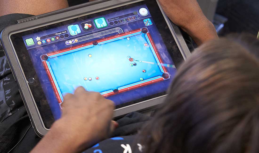 A person playing a game on a tablet.